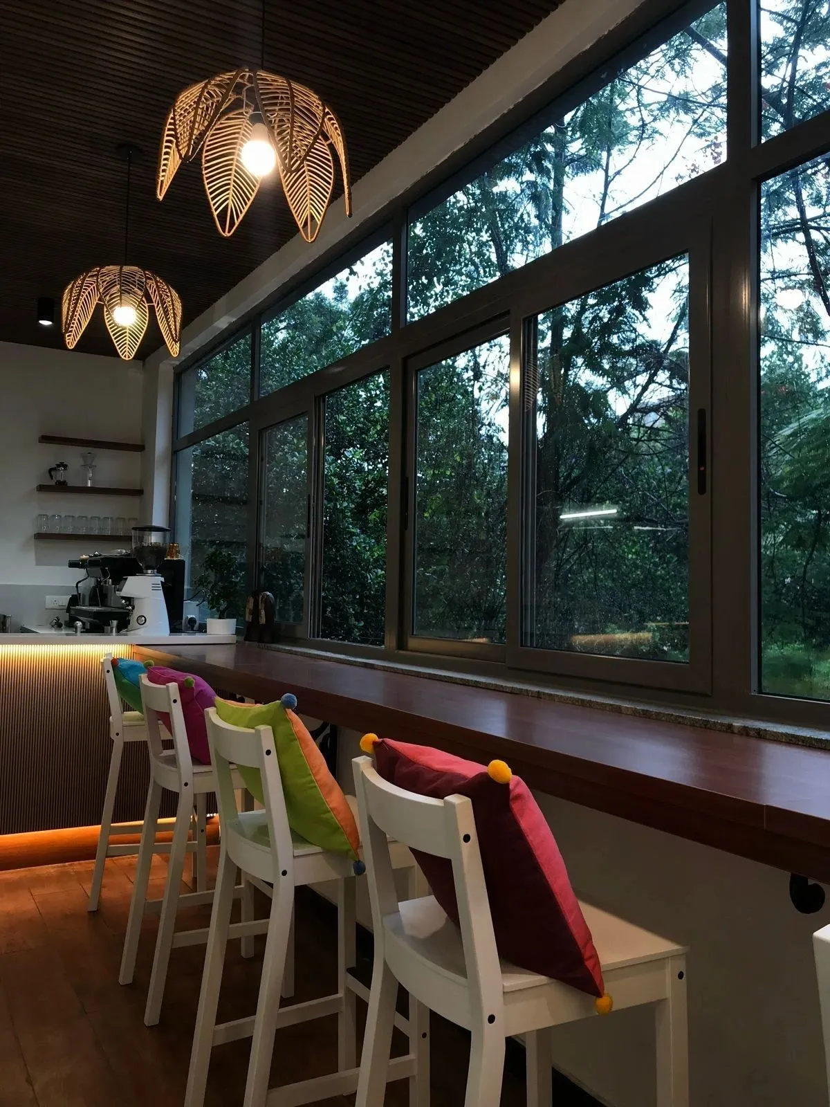 Café Fiori window bar with woven pendant lights and garden view