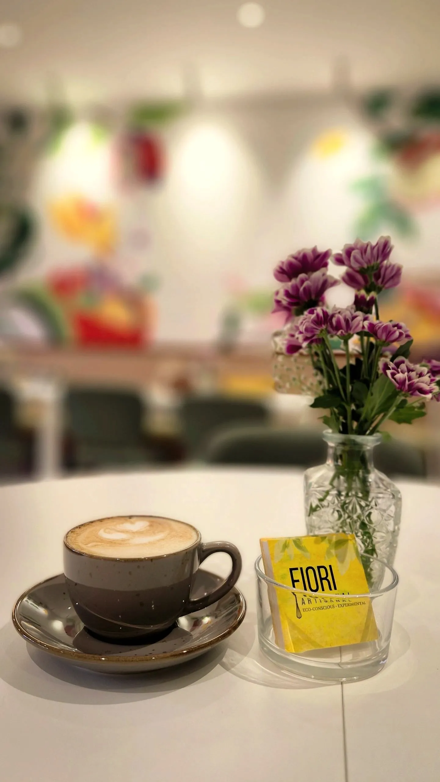 A latte and fresh flowers at Café Fiori