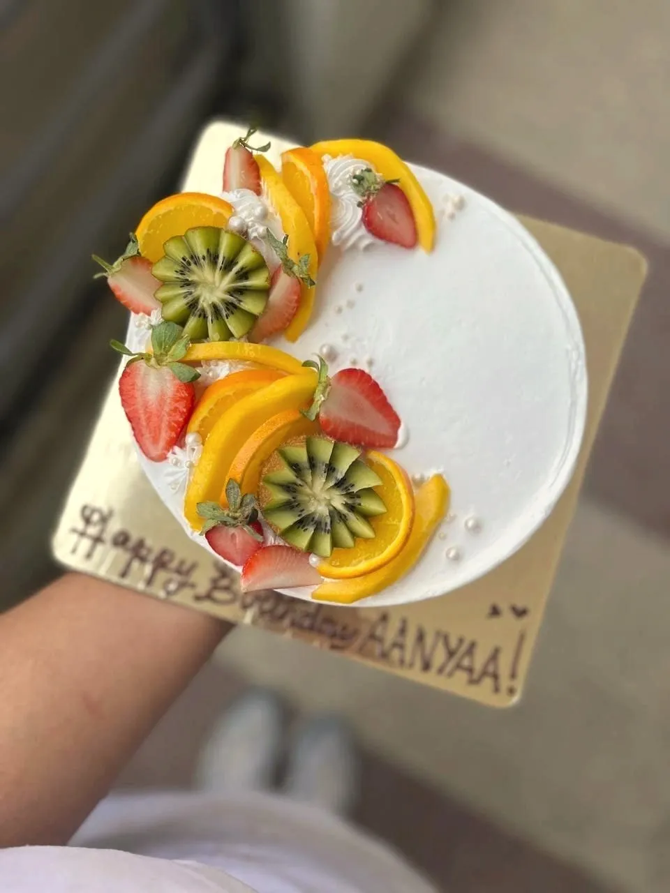 Birthday cake topped with fresh fruit