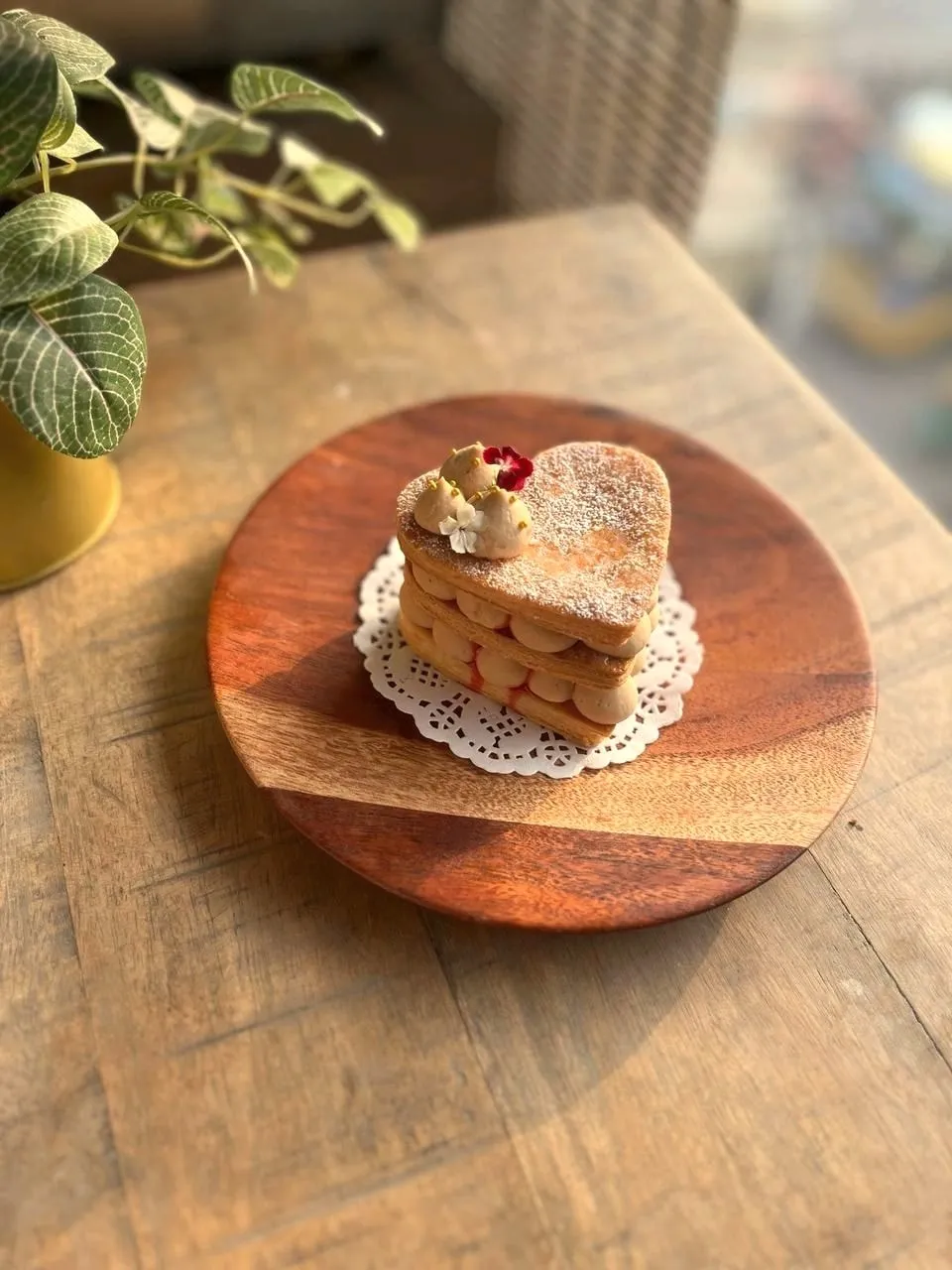 Heart-shaped mille-feuille on a wooden plate