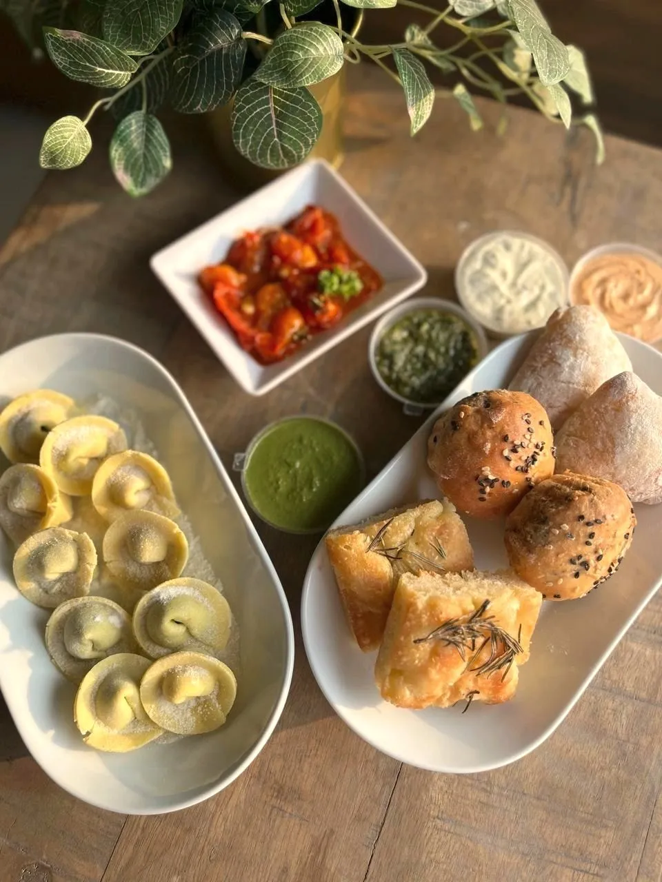 Savoury platter of filled pasta, buns and dips